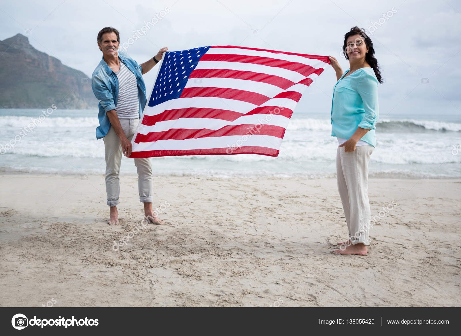 Couple holding american flag on beach — Stock Photo © Wavebreakmedia