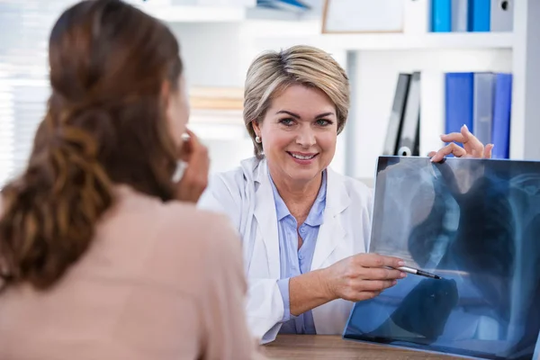 Γυναίκα γιατρό εξηγώντας έκθεση ακτινογραφία σε ασθενή — Φωτογραφία Αρχείου