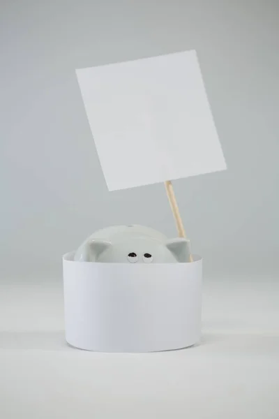 Piggy bank with placard sign board — Stock Photo, Image