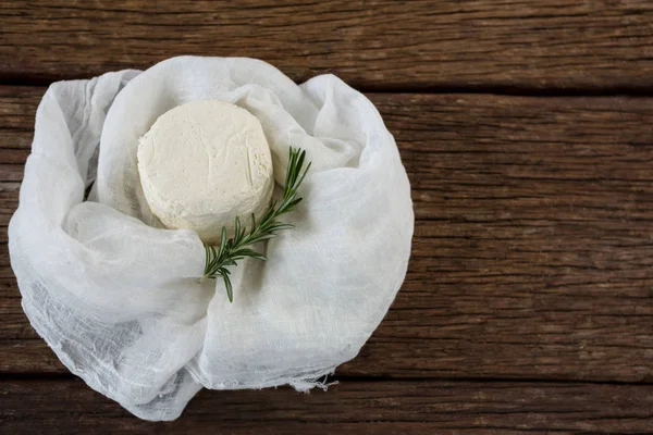 Cottage cheese and rosemary herb in white cloth — Stock Photo, Image