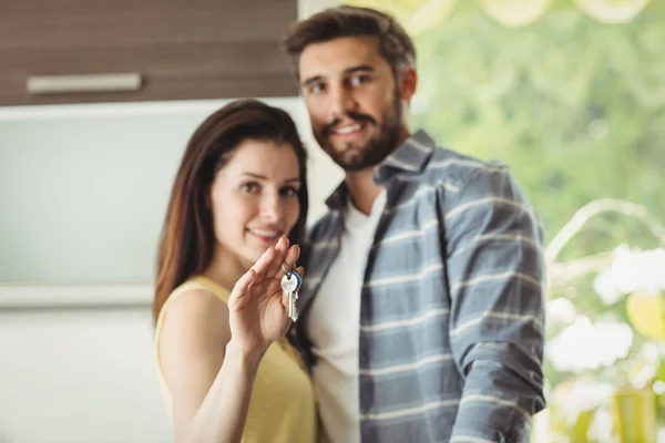 Pareja sosteniendo llaves en su nueva casa — Foto de Stock