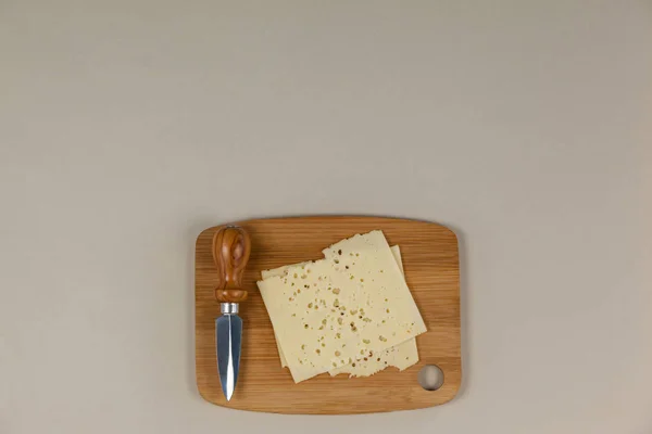 Slices of cheese with knife — Stock Photo, Image