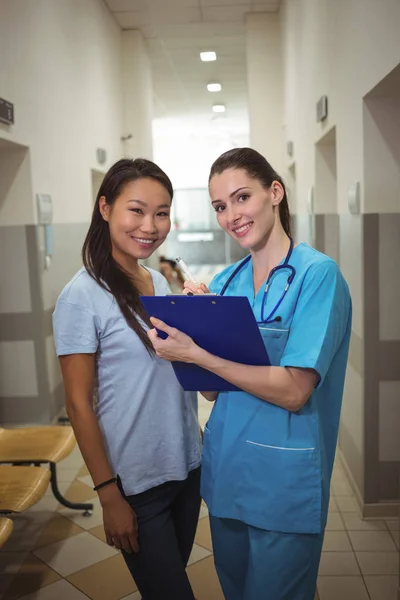 Femme médecin et patiente dans le couloir — Photo