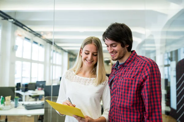 Graphic designers discussing over document — Stock Photo, Image