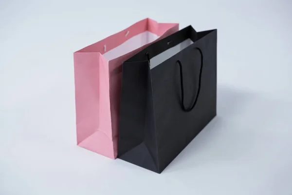 Black and pink shopping bags — Stock Photo, Image