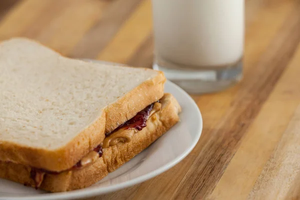 Peanut butter and jam sandwich on plate — Stock Photo, Image