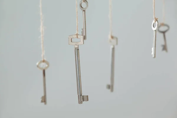 Keys hanging on strings — Stock Photo, Image