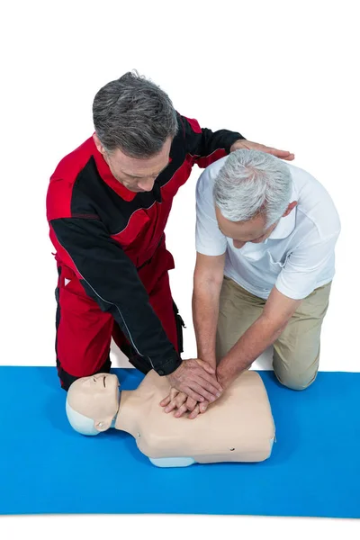 Paramedic training cardiopulmonary resuscitation to man — Stock Photo, Image