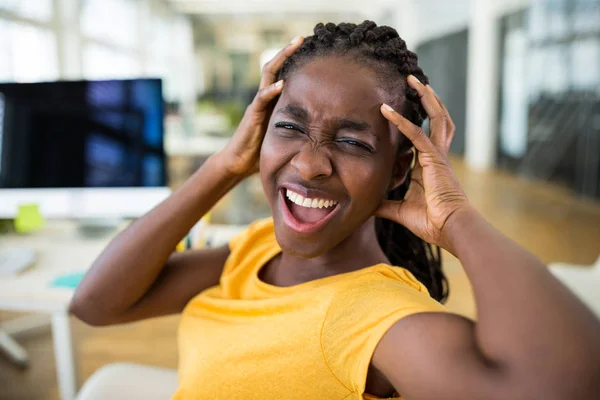 Frustrated female business executive at desk — Stock Photo, Image