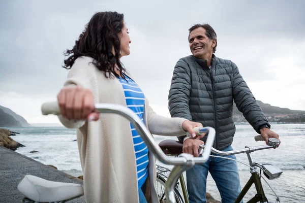 Couple on bicycle interacting with each other — Stock Photo, Image