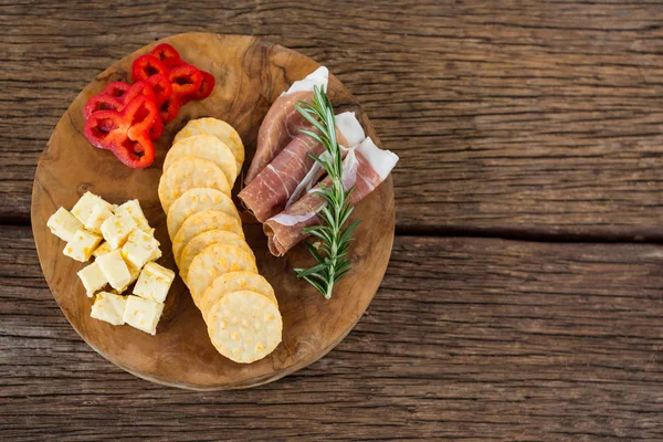 Cheese, red pepper slices, meat and nacho chips — Stock Photo, Image