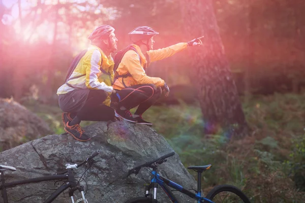 Biker pár sezení a ukazující ve vzdálenosti — Stock fotografie