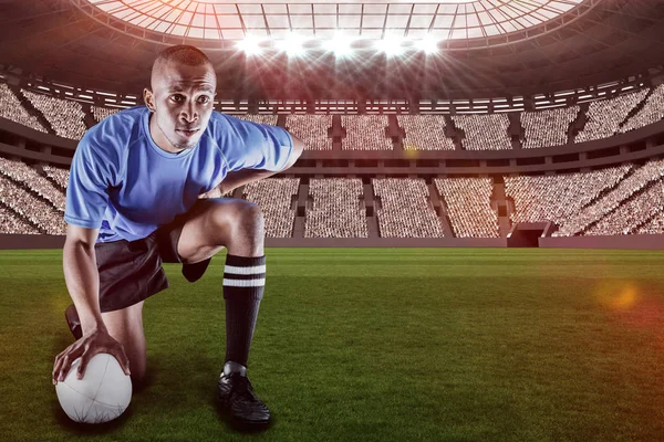 Serious rugby player kneeling — Stock Photo, Image