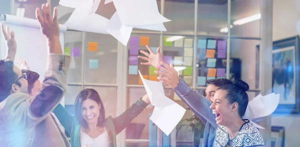 Celebrating business people throwing papers in the air — Stock Photo, Image