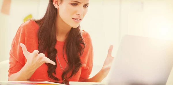 Designer gesturing in front of her laptop — Stock Photo, Image