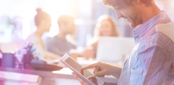 Smiling young man using digital tablet — Stock Photo, Image