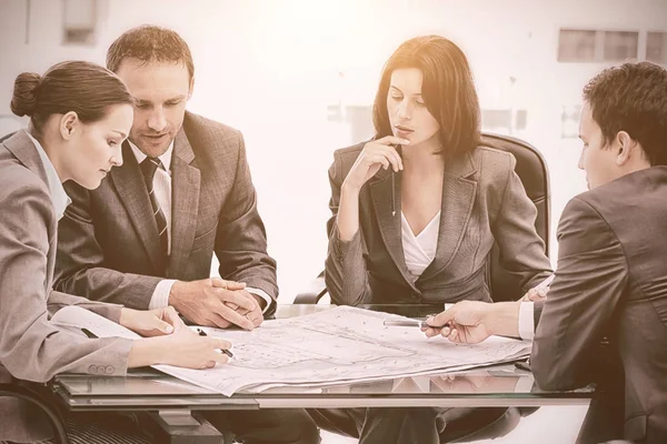 Serious engineers looking at plans — Stock Photo, Image