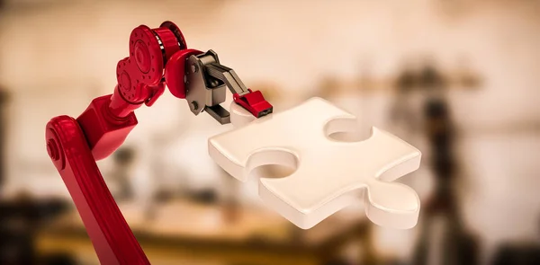 Czerwony robotic ręka trzyma kawałek układanki — Zdjęcie stockowe