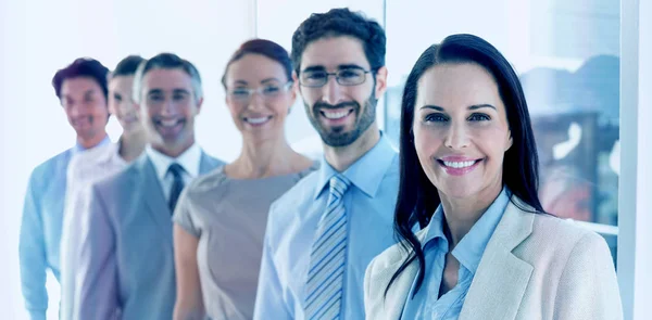 Smiling employees in a line — Stock Photo, Image