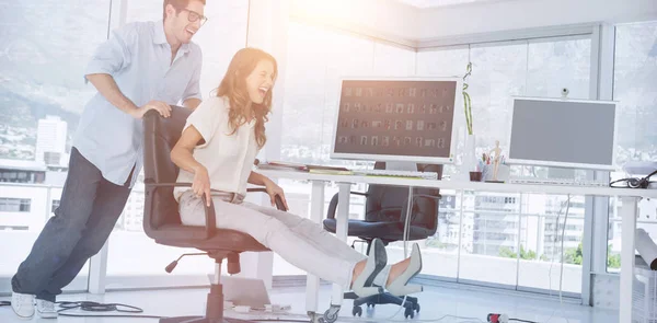 Designers having fun with a swivel chair — Stock Photo, Image