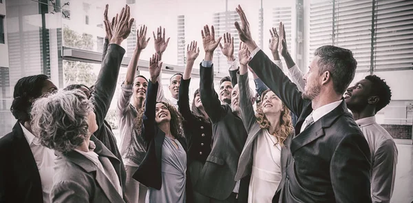 Business people raising their arms — Stock Photo, Image