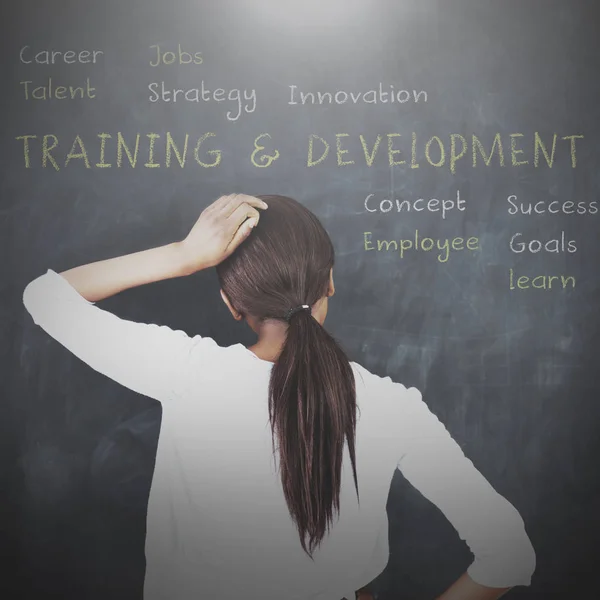 Woman looking at a chalkboard — Stock Photo, Image