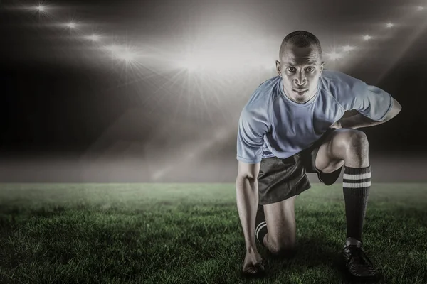 Confident sportsman kneeling — Stock Photo, Image