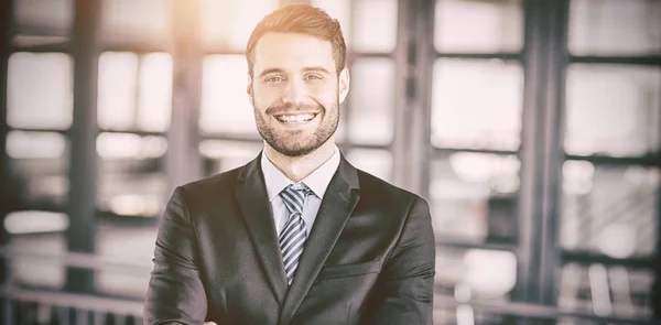 Happy businessman with arms crossed — Stock Photo, Image