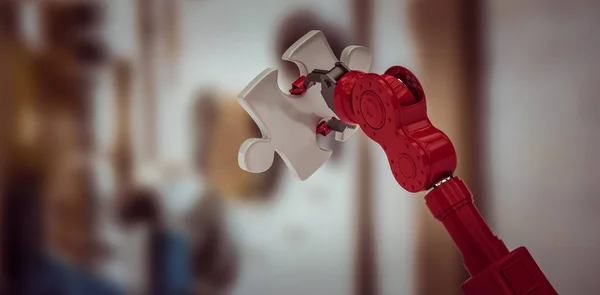 Robotická ruka drží kousek skládačky — Stock fotografie