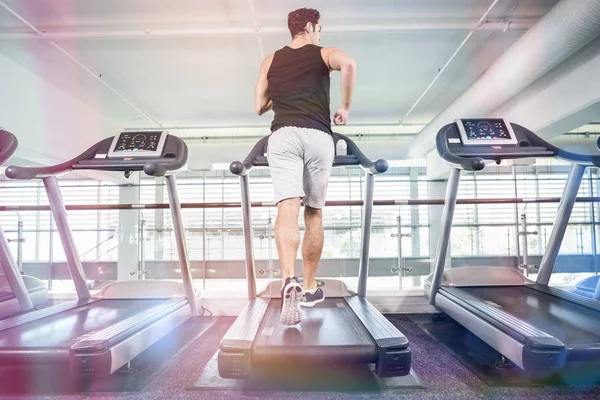 Hombre en forma corriendo en la cinta de correr —  Fotos de Stock