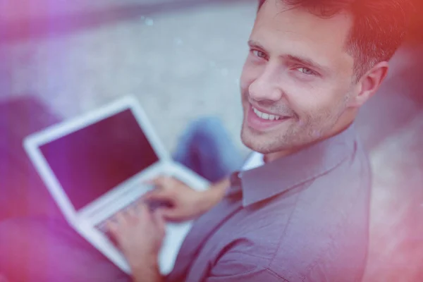 Handsome business executive using laptop — Stock Photo, Image