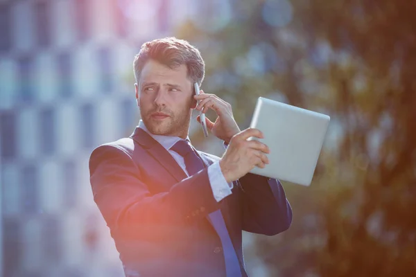 Hombre de negocios guapo hablando por teléfono móvil — Foto de Stock