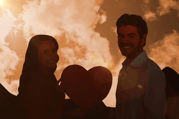 Couple holding paper heart — Stock Photo, Image