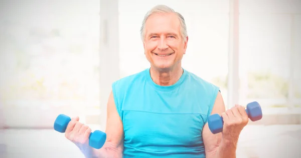 Senior man exercising with dumbbells — Stock Photo, Image