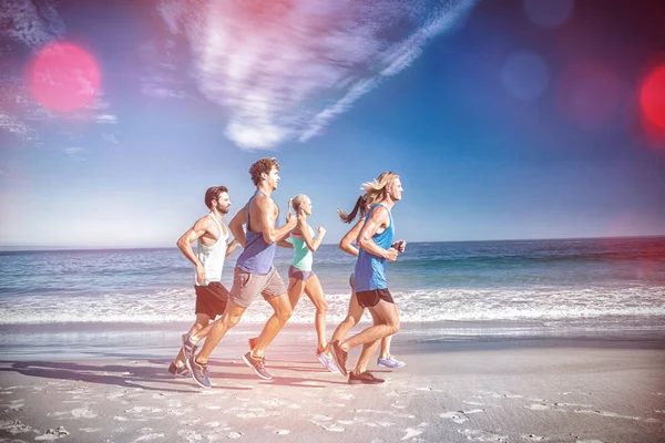 People jogging on beach — Stock Photo, Image