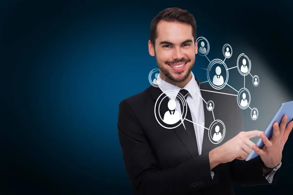 Businessman using his tablet while looking at the camera — Stock Photo, Image