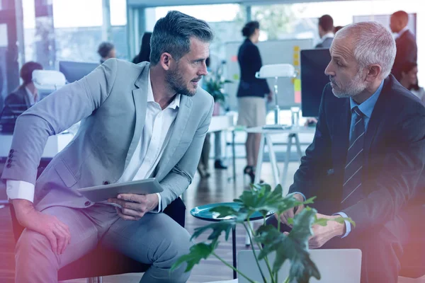 Business people interacting while using digital tablet — Stock Photo, Image