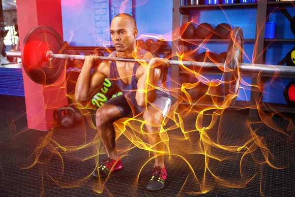 Male athlete weightlifting in fitness studio — Stock Photo, Image