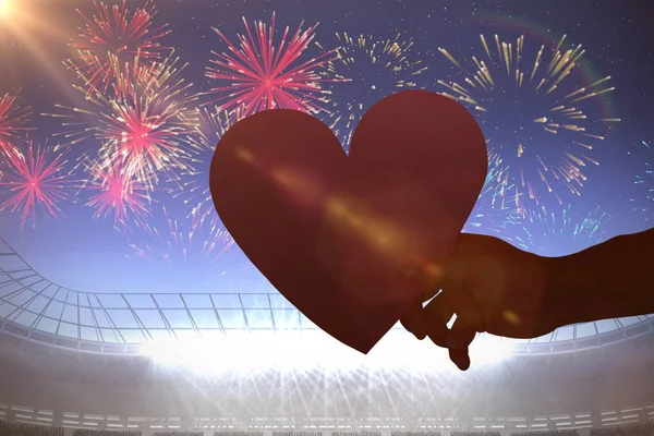 Heart against fireworks exploding — Stock Photo, Image