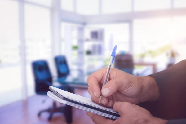 Man writing in spiral book — Stock Photo, Image