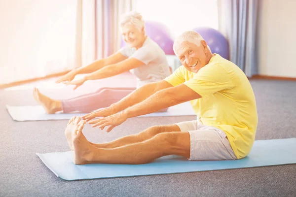 Portrait of seniors stretching legs — Stock Photo, Image