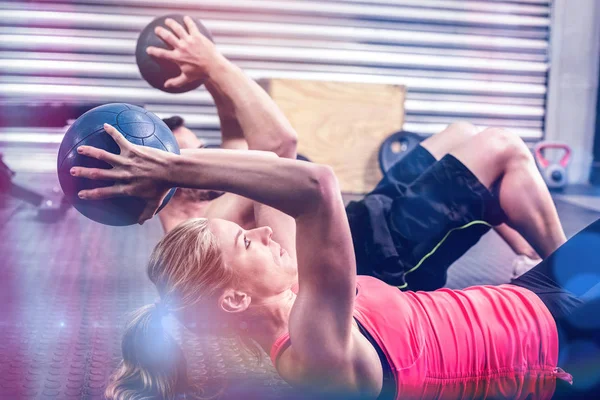 Ajuste pareja haciendo ejercicio de pelota abdominal —  Fotos de Stock