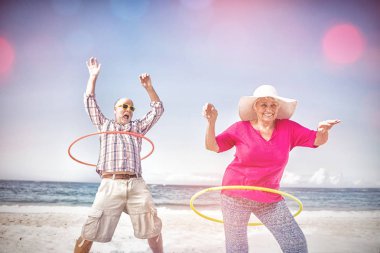 Senior couple doing hula hoop clipart