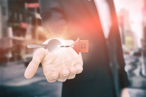 Key with keychain in man hand — Stock Photo, Image