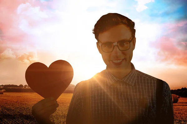 Geeky hipster κρατώντας μια κάρτα καρδιά — Φωτογραφία Αρχείου