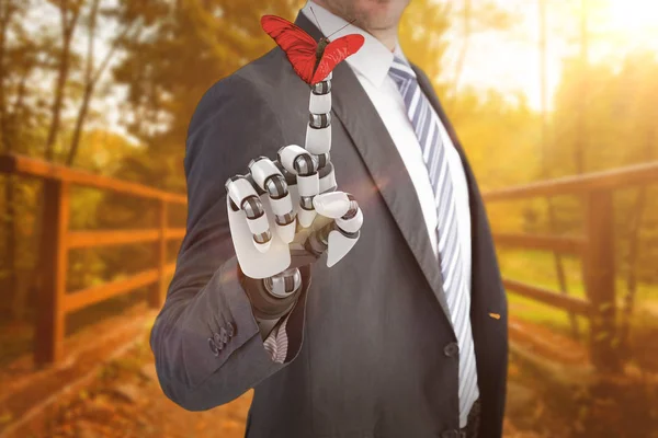 Businessman with robot hand and butterfly — Stock Photo, Image