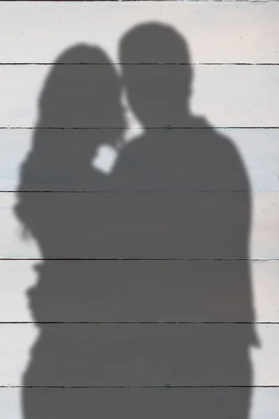 Silhouetten van paar tegen houten planken — Stockfoto