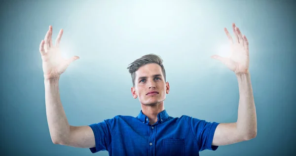 Man in blue shirt with arms raised — Stock Photo, Image