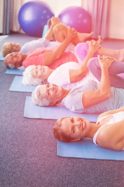 Portrait of instructor performing yoga with seniors — Stock Photo, Image