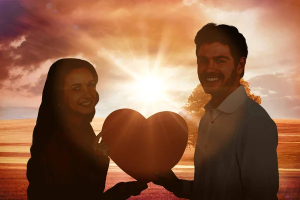 Couple holding paper heart — Stock Photo, Image